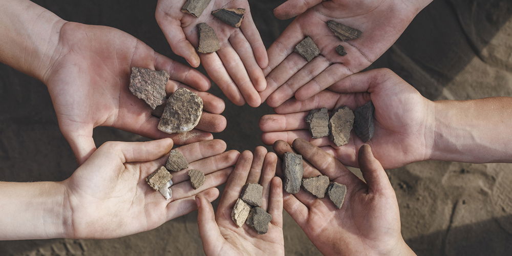 Hands Holding Fossils