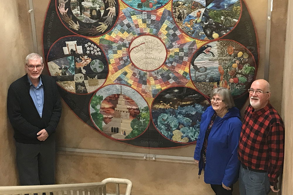 Ken Ham, Lydia Breitkreuz in Front of Quilt