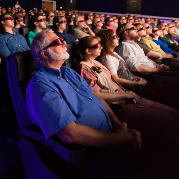 People with 3D glasses watching screen